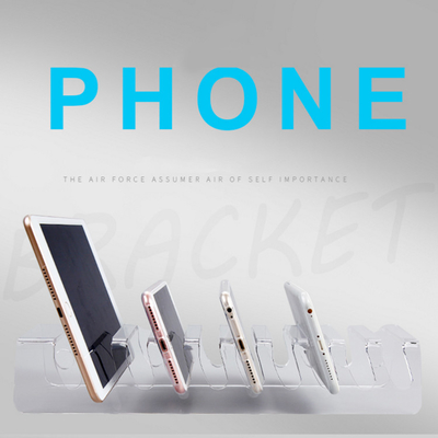 Pequeños soportes de exhibición de acrílico de la venta al por menor del cojín del teléfono celular del claro de la exhibición de la encimera